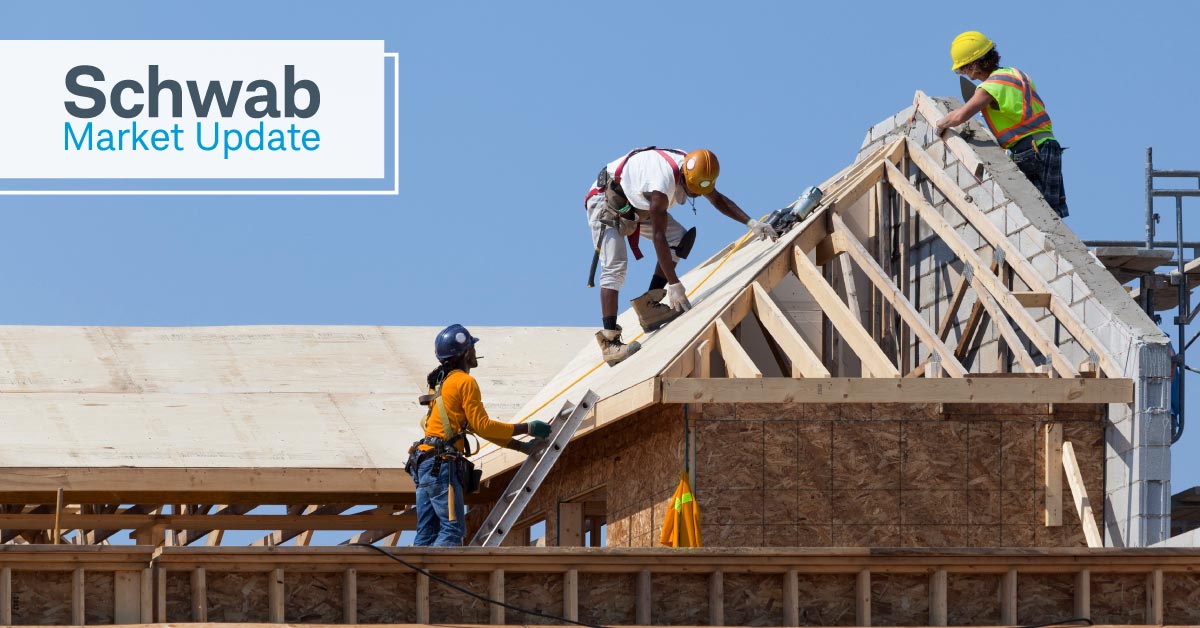 Schwab Market Update: Construction workers working on the roof of a house. 