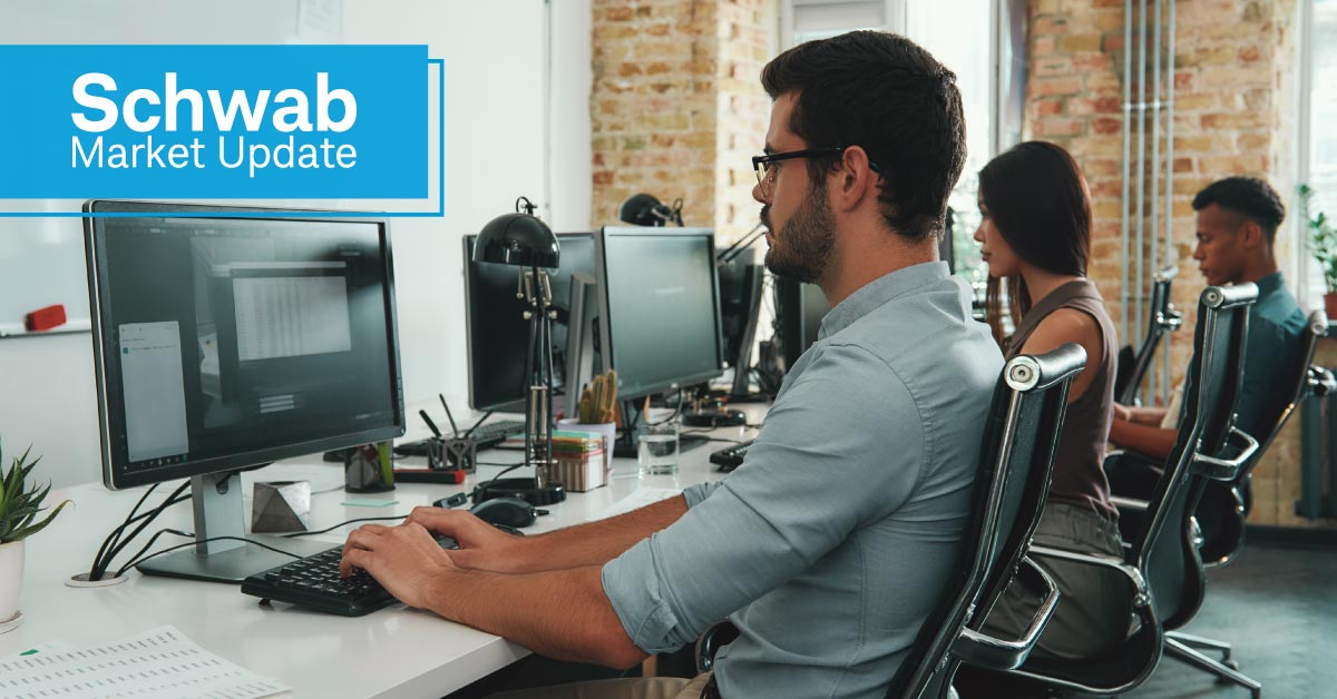 Schwab Market Update: Office workers at their computers.