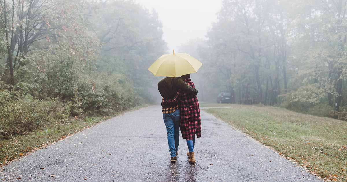 Couple walking in the rain under an umbrella