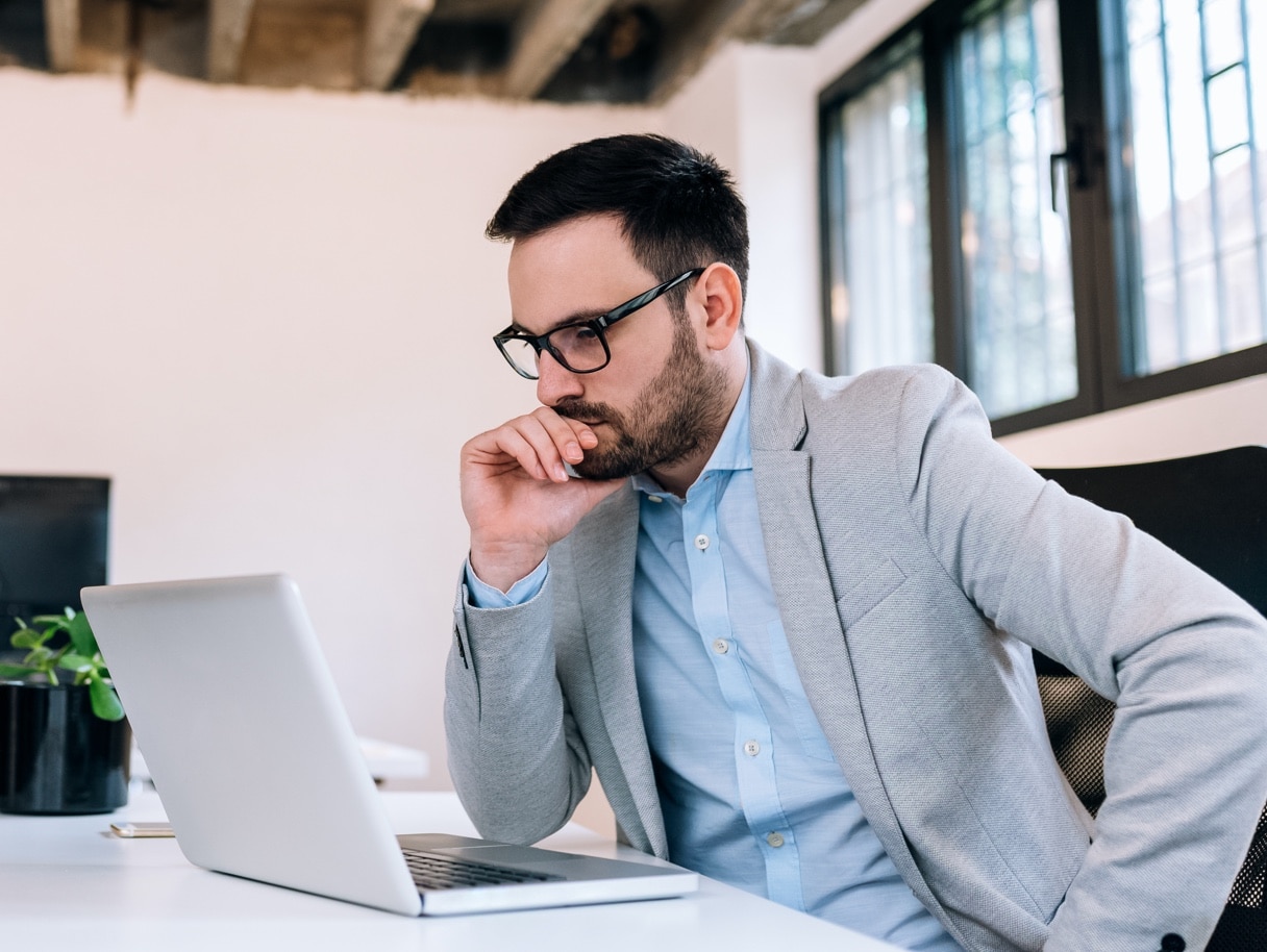 Male international investor looking at laptop