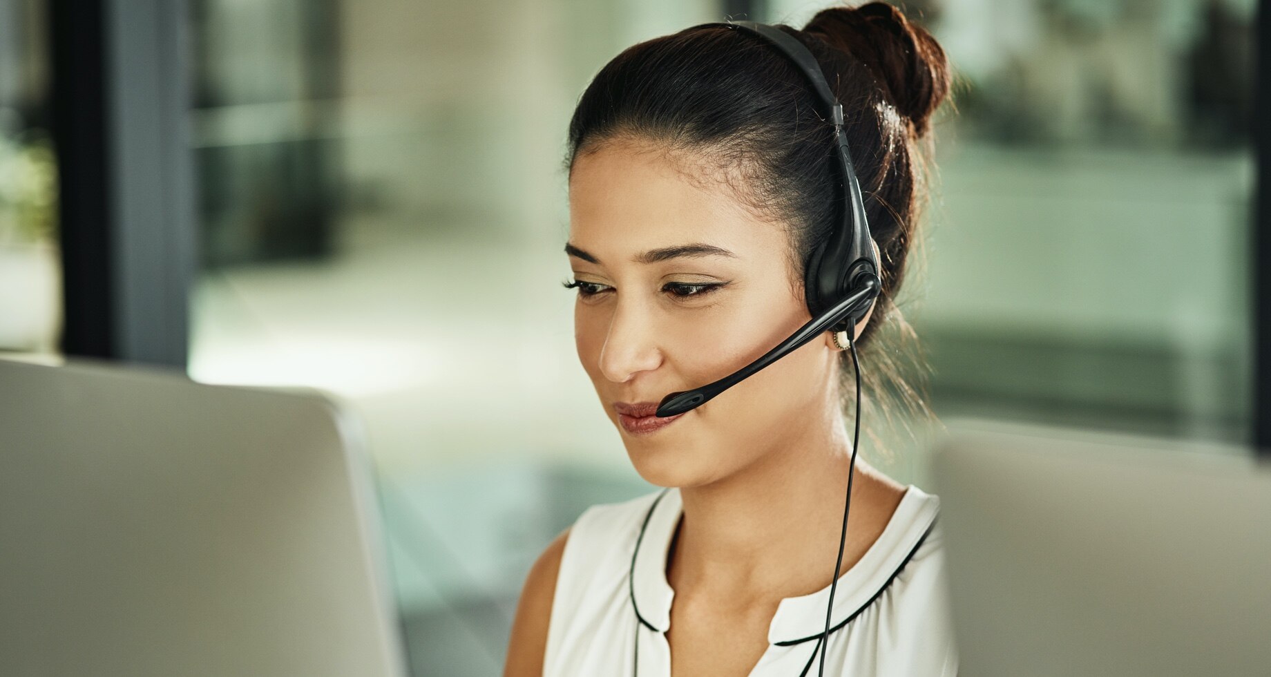 Female options specialist on headset
