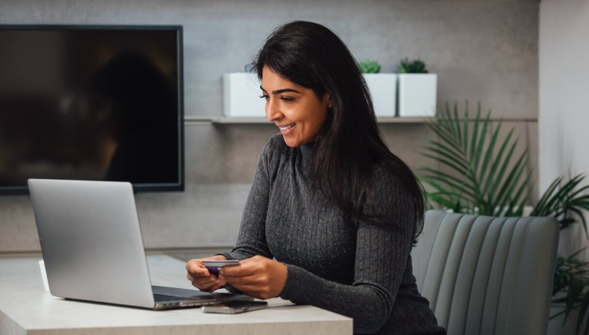 Female international investor on sofa looking at tablet